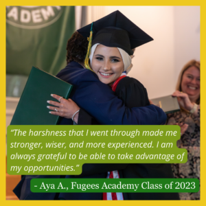 Two females hug at graduation ceremony