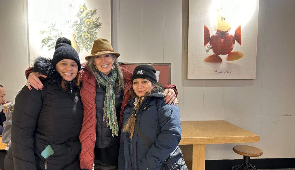 Laura, Silenny, and Arlen are pictured together, smiling in a Pret restaurant